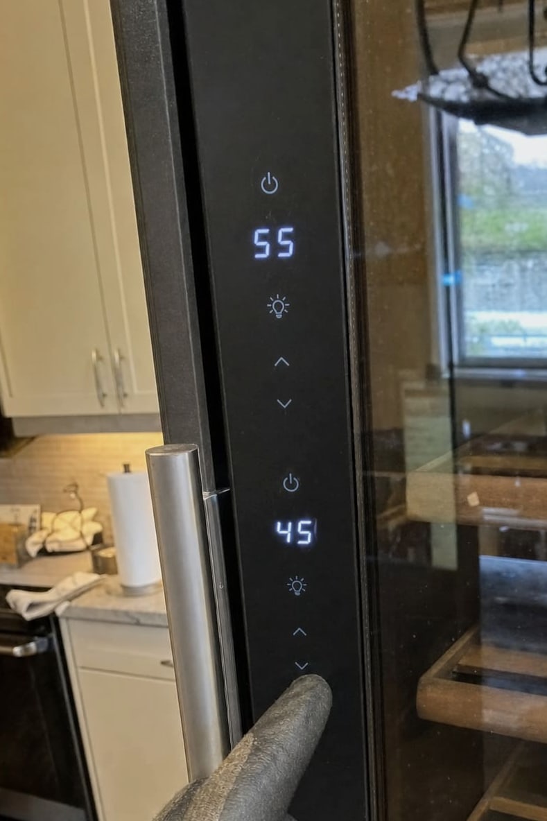 Wine cooler control panel with the upper and lower zone temperatures lit in blue