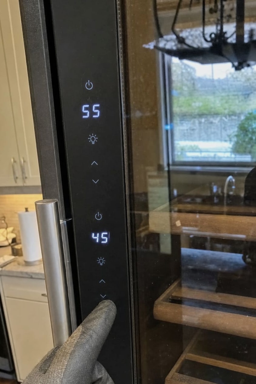Wine cooler touch control panel showing 55 degrees on the upper zone and 45 degrees on the lower zone